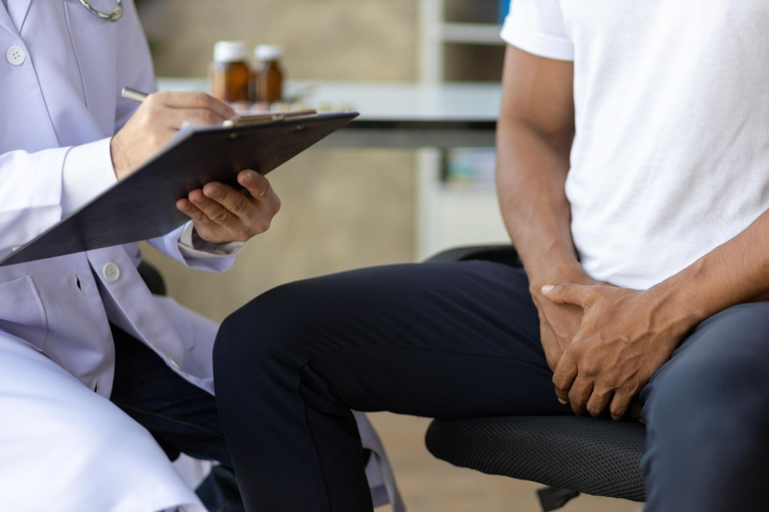 Doctor writing on clipboard