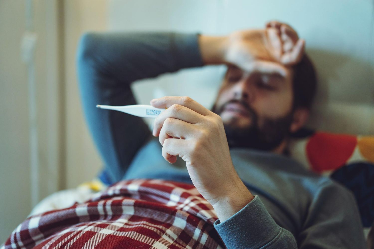 Person lying in bed unwell