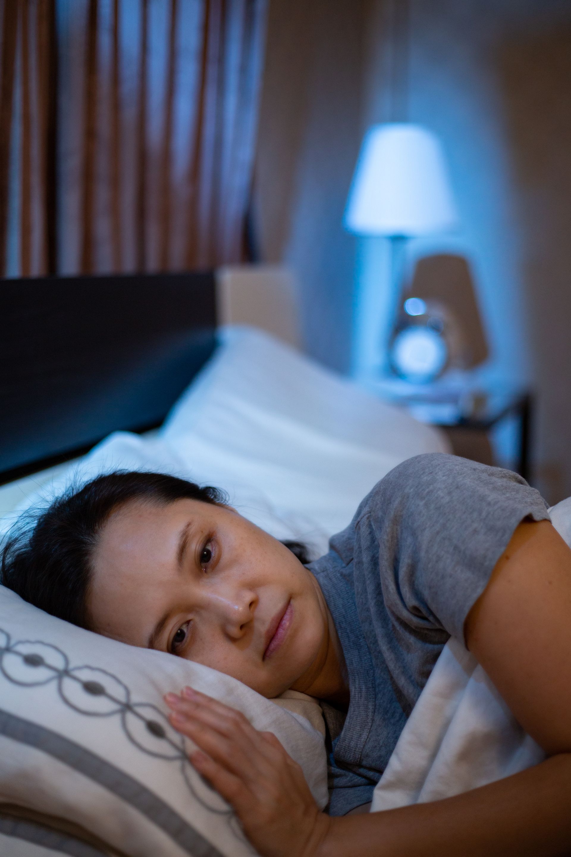 Woman lying awake in bed