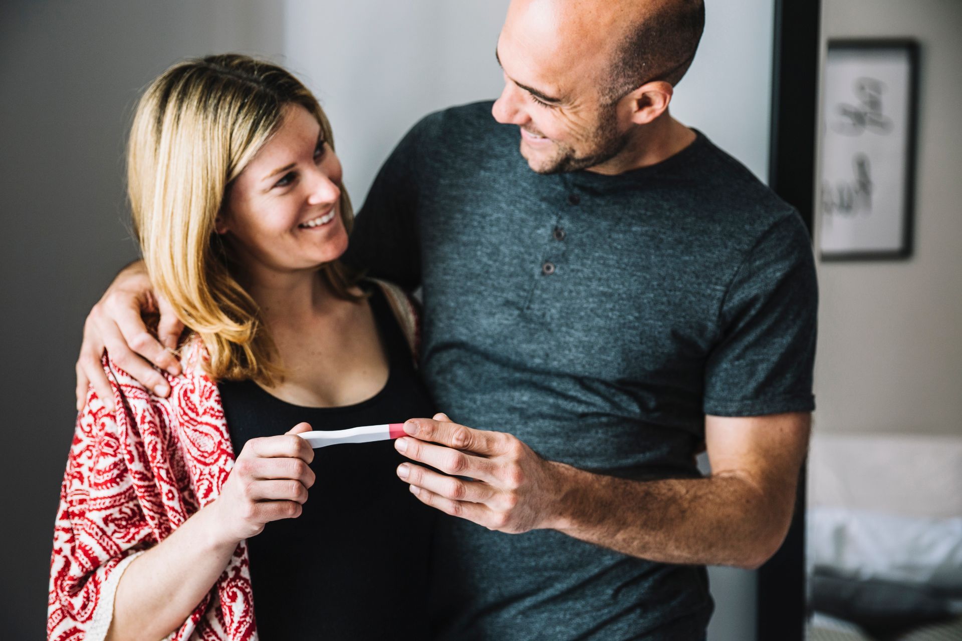 A man and a woman looking at a pregnancy test