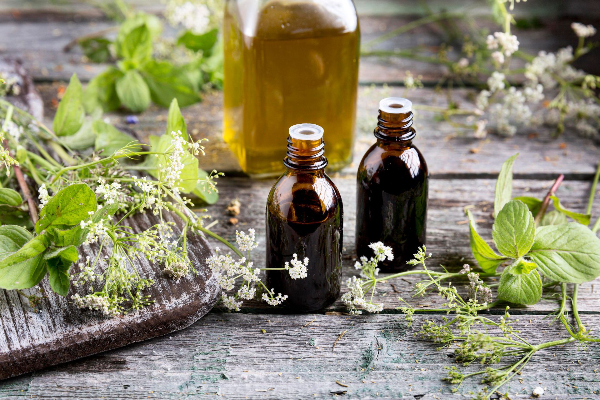 Three bottles of essential oil on a wooden table