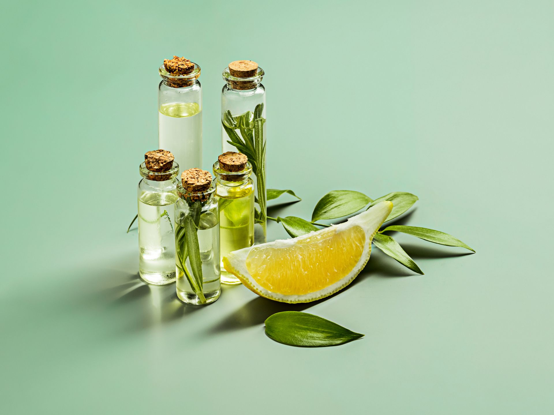 Olive oil and olive branch on wooden table