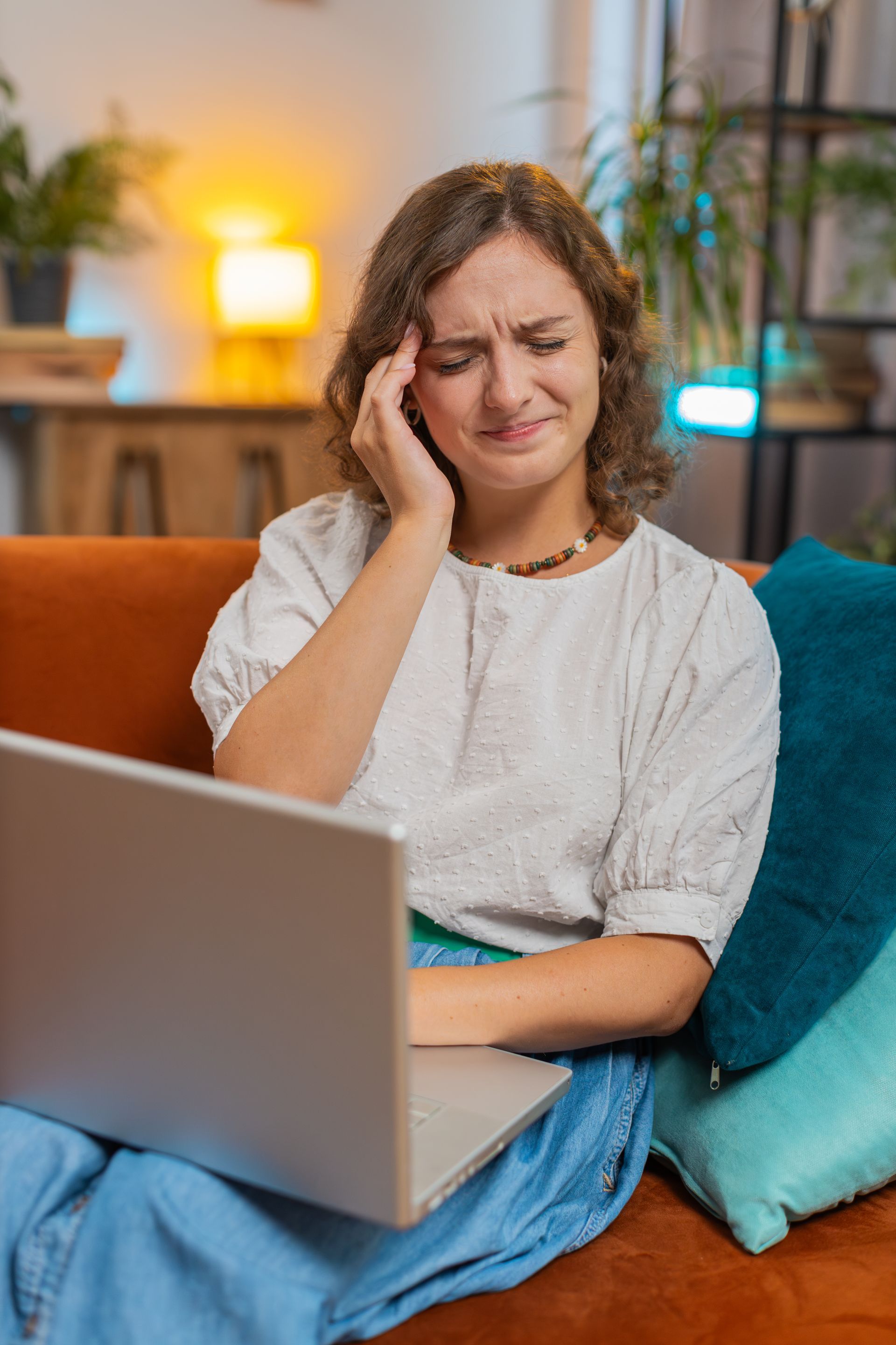 Woman with a headache at her laptop