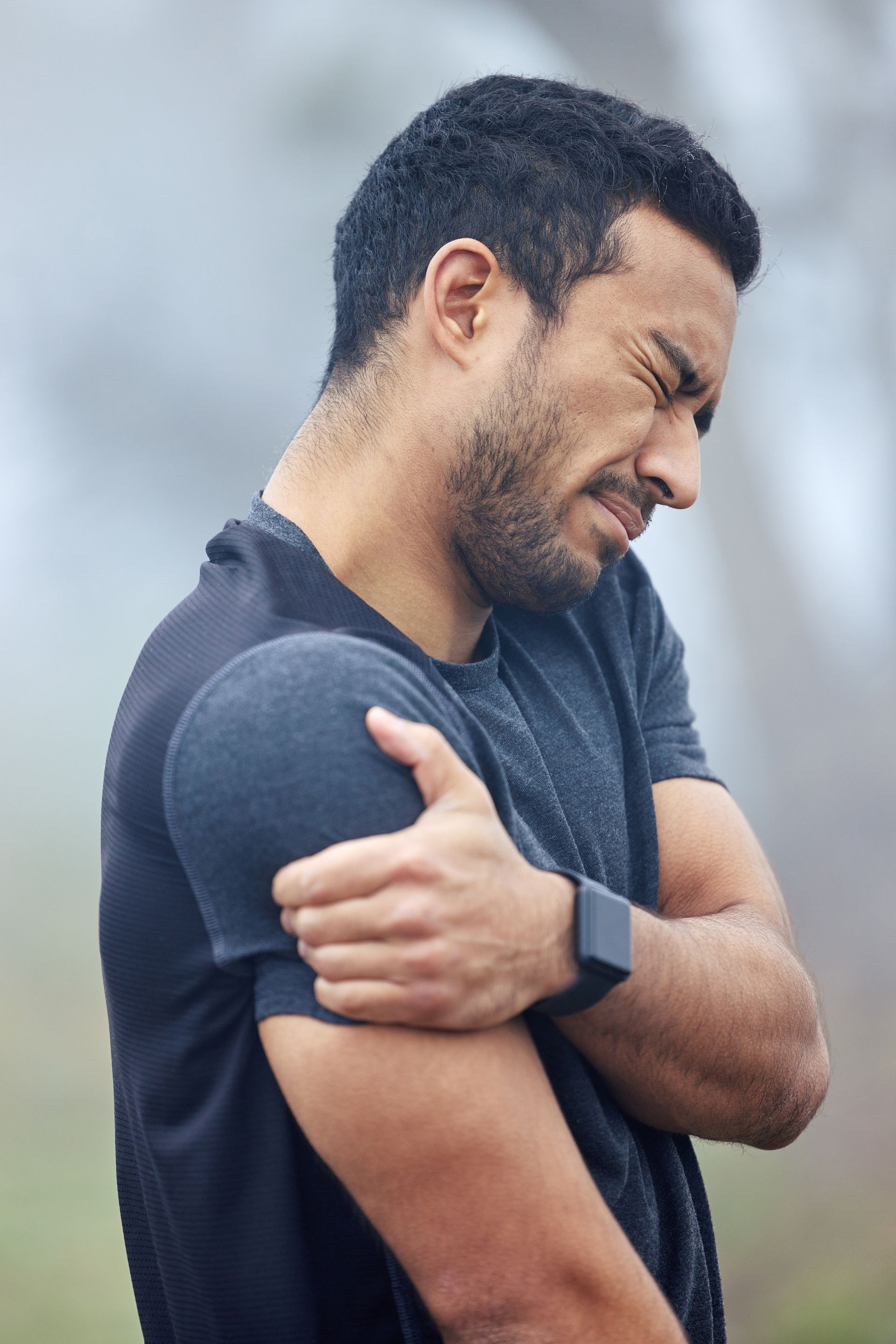 Man holding his shoulder in pain